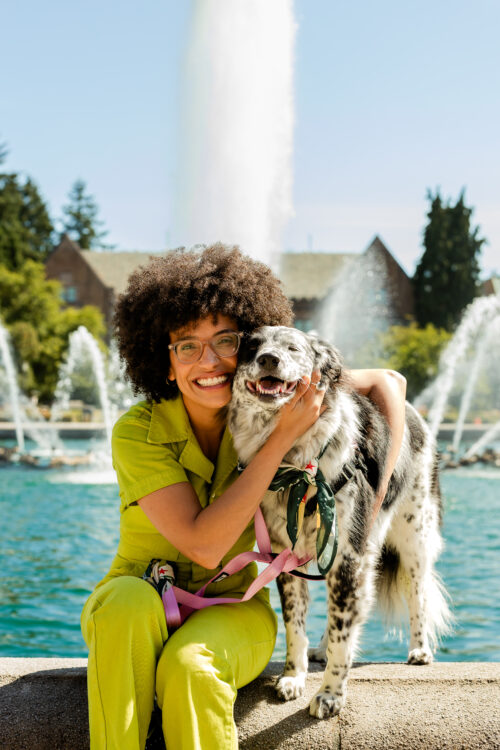 UW employee poses with their furry friend captured by Diogo Fagundes at the Fountain