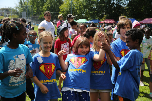 4 kids arm wrestling in superman shirts