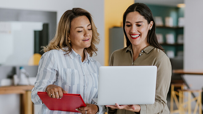 two women looking at computers