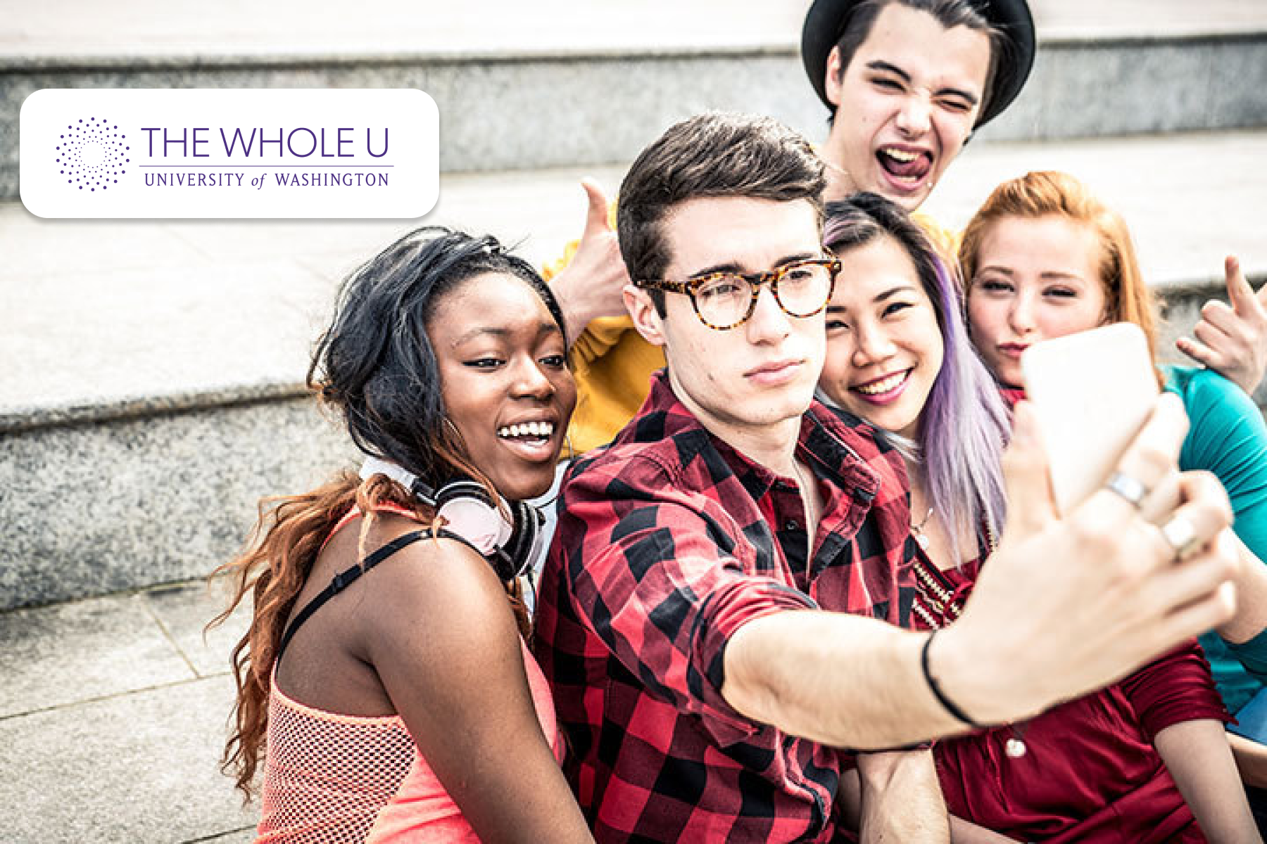 Five young adults smiling for a selfie