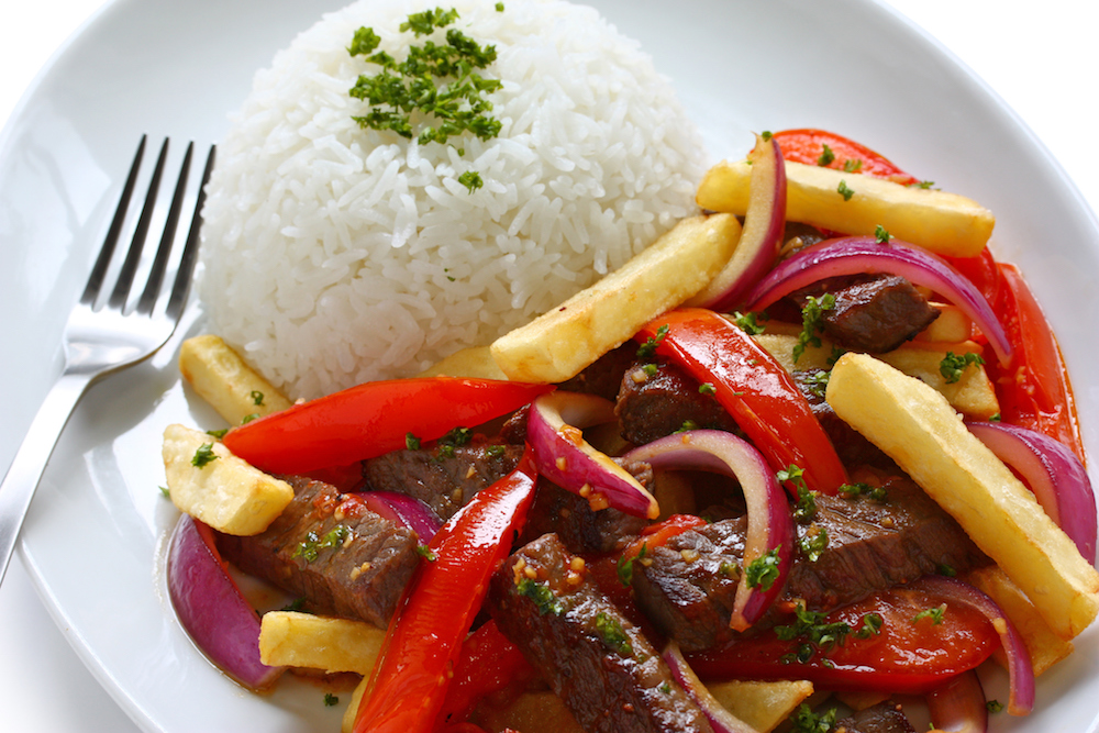 beef steak sauteed in olive oil with onions and tomatoes served over french fries and rice.