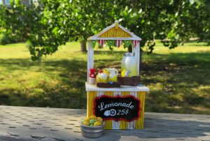 Lemonade stand in front of a green back drop with a price labeled $0.25.