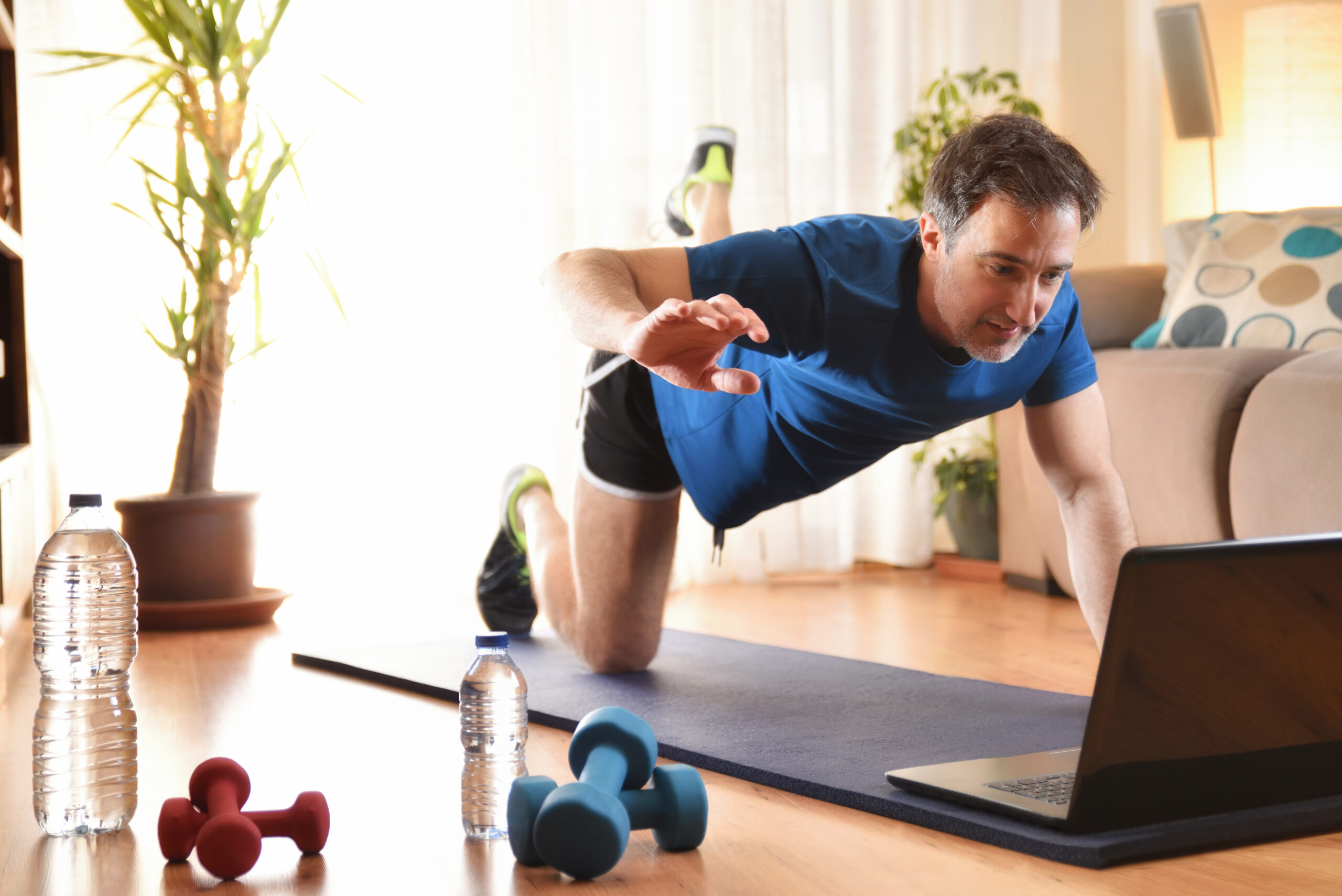 man strength training in living room