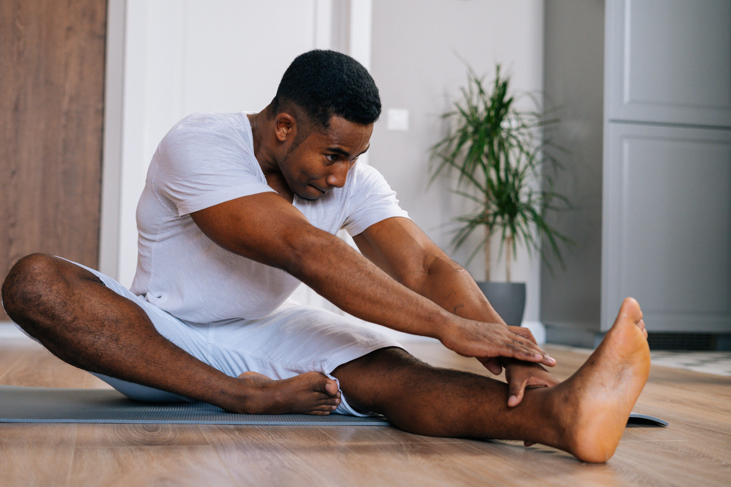 man doing yoga on floor mat