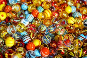 close up image of a pile of colorful glass marbles.