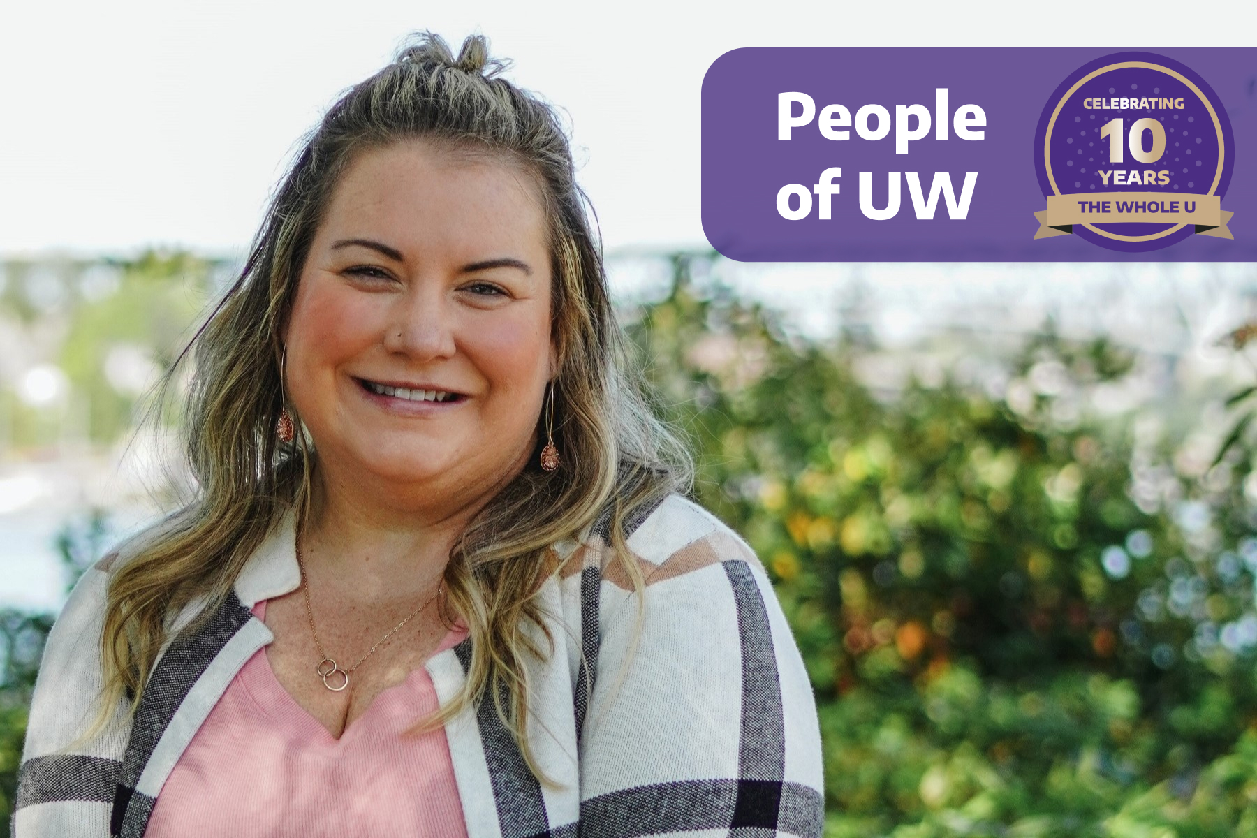A woman poses outside with the banner "People of UW"