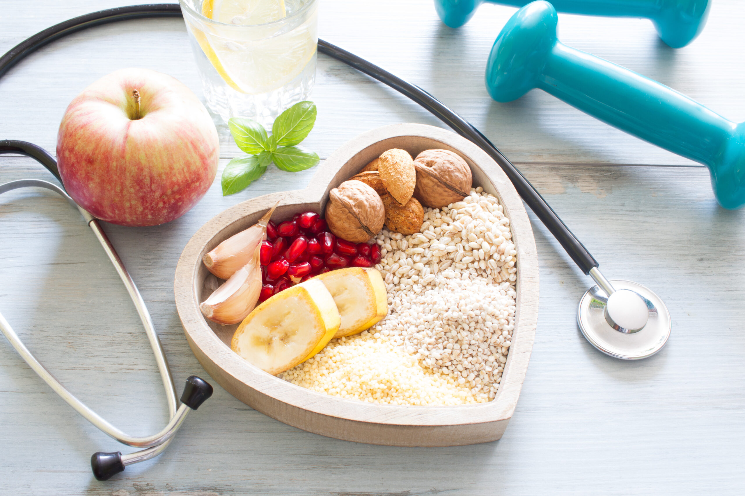 food in shape of heart with stethoscope and weights