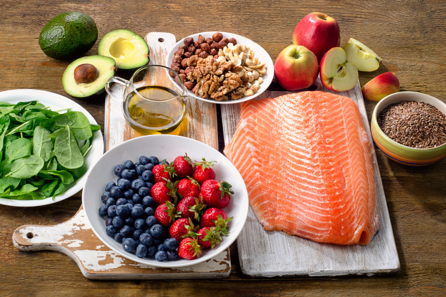 greens, salmon, fruit and vegetables on table display